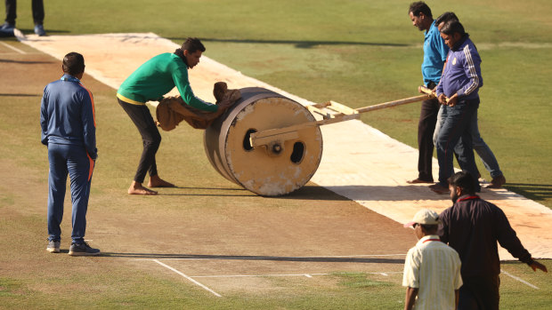 Ground staff work on pitch preparation for the third Test in Indore.