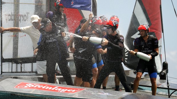 Team New Zealand helmsman Pete Burling sprays champagne after defeating Oracle Team USA in the America's Cup in 2017.