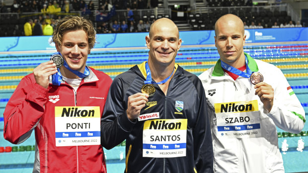 Nicholas Santos of Brazil (middle) receives his gold medal after winning the men’s 50m butterfly at the World Shortcourse Championships.