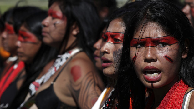 Indigenous women of the Xingu tribe sing ritual songs during the big march of the annual three-day campout protest known as The Free Land Encampment, outside Congress in Brasilia last week.