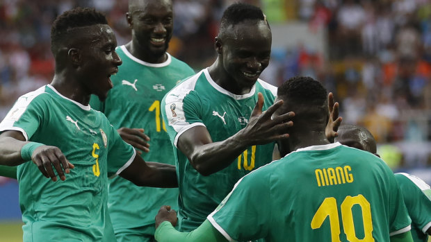 On top: Mbaye Niang is congratulated after grabbing Senegal's second goal.