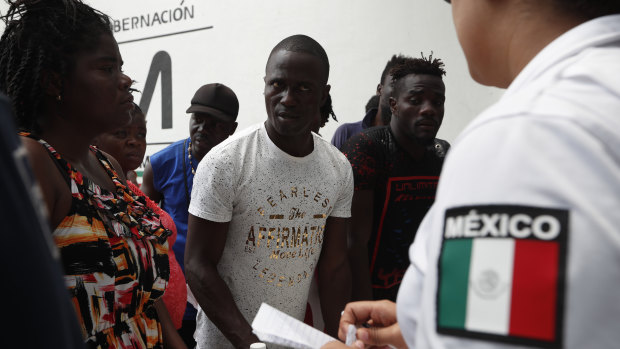 Migrants, mostly from Africa, wait for a ticket to register their entry into Mexico at an immigration station in Tapachula.