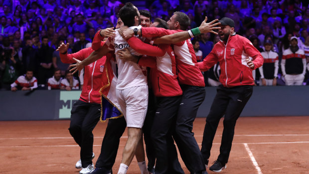 Marin Cilic is mobbed by Croatian teammates after they won the Davis Cup.