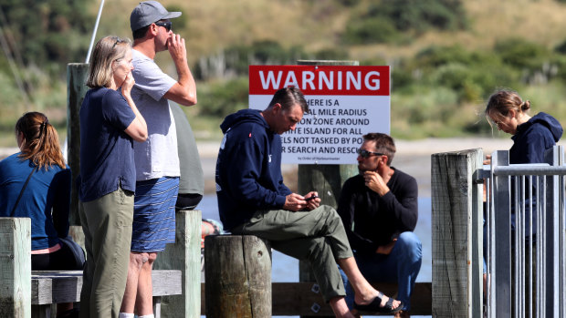 People comforting each other at Whakatane following the White Island volcano eruption.