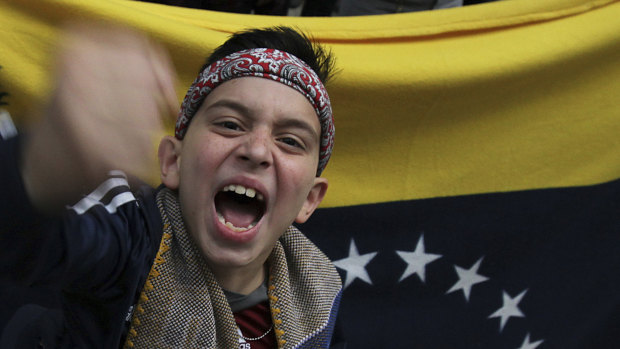A Venezuelan boy joins a protest outside the Venezuelan embassy in Mexico City in January.