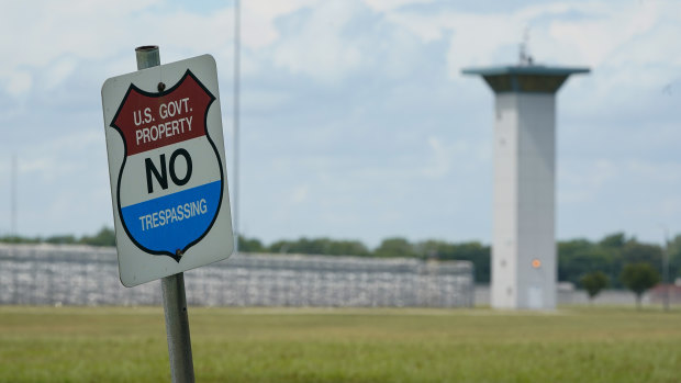 A no trespassing sign is displayed outside the federal prison complex in Terre Haute, Indiana.