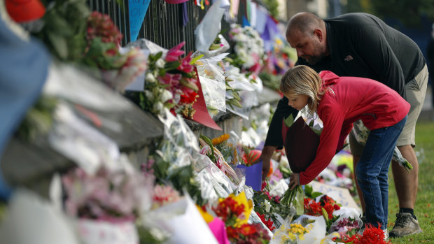 Mourners lay flowers on a wall at the Botanical Gardens in Christchurch, New Zealand.