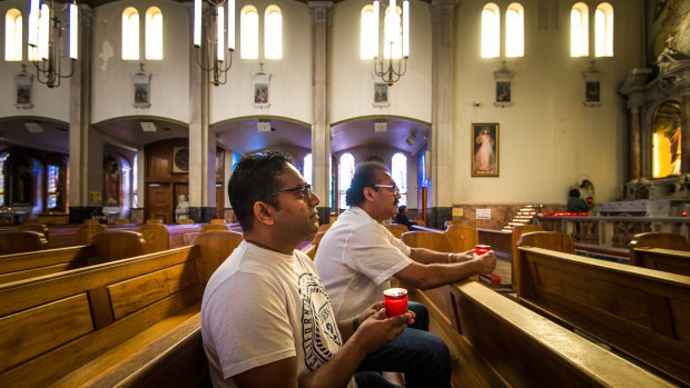 Muslim and Buddhist friends mourn Alexendria and Manik at the Catholic church the family once visited every week.