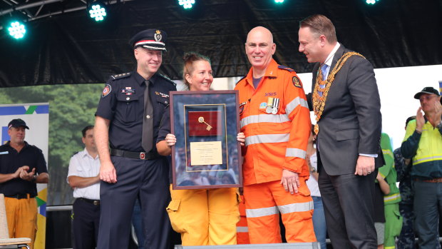 Rural Fire Service firefighter Lisa Camus, SES volunteer Paul Cantarella and QFES Inspector Mark Burchard received keys to the city on behalf of their organisations.