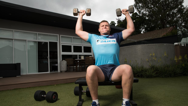 Waratahs prop Angus Bell works out in his backyard in Putney. 