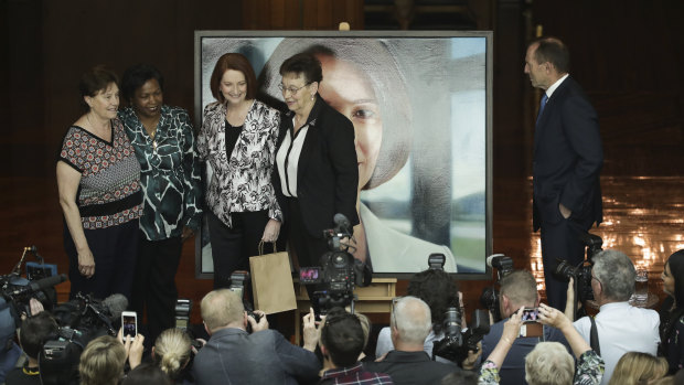 Former prime minister Julia Gillard poes for a photo with  Parliament House cleaners Anna Jancevski, Luzia Borges  and Maria Ljubic while Tony Abbott looks on.