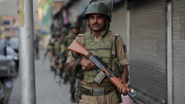 Indian soldiers patrol in Srinagar, India, on Sunday amid rising tensions.