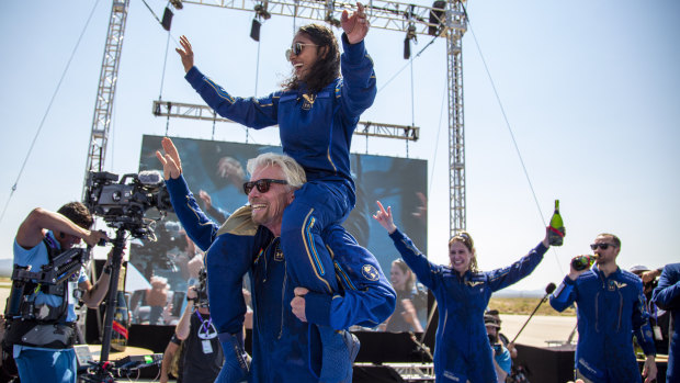 Virgin Galactic founder Richard Branson carries crew member Sirisha Bandla on his shoulders while celebrating their flight to space. 