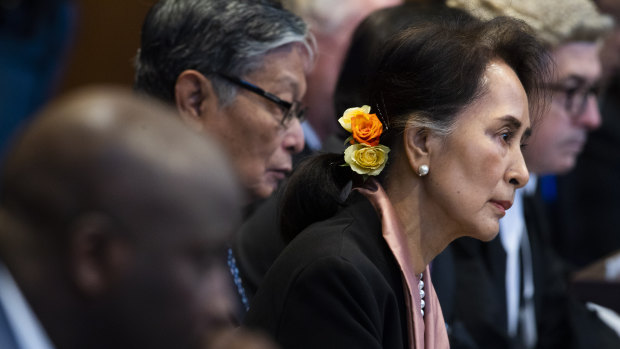 Myanmar's leader Aung San Suu Kyi and Gambia's Justice Minister Aboubacarr Tambadou, left, listen to judges in the court room.