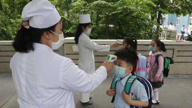 Students have their temperature checked in Seoul in June. 