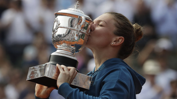 Romania's Simona Halep kisses the trophy.