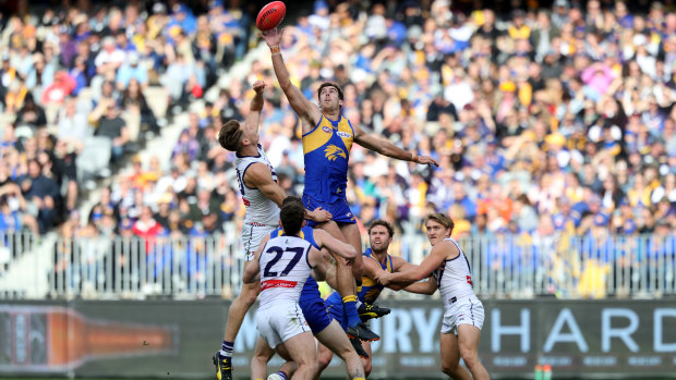 Big men fly: Eagle Scott Lycett takes on Matt Taberner of the Dockers in a ruck contest.