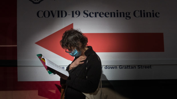 A woman waits outside a coronavirus testing station at Royal Melbourne Hospital on Thursday.