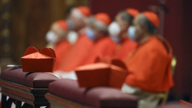 Cardinals sit as Pope Francis celebrates Mass last year at St Peter’s Basilica. 