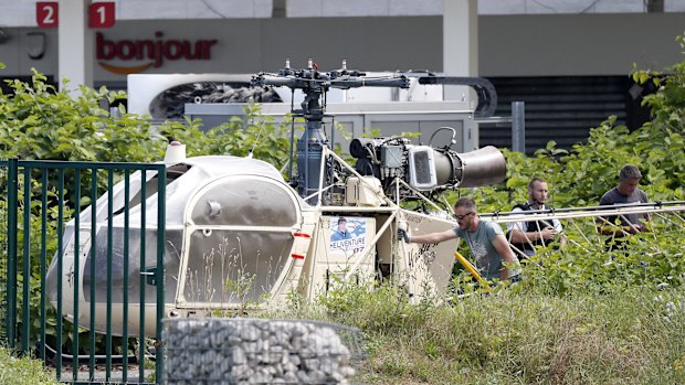 Investigators transport an Alouette II helicopter believed to have been abandoned by French prisoner Redoine Faid and suspected accomplices in July.