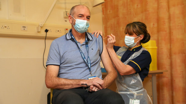 Professor Andrew Pollard, the director of the Oxford Vaccine Group, receives the jab given his status as a frontline health worker. 