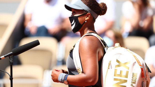 Naomi Osaka talks to a courtside interviewer after her first-round win at the French Open.