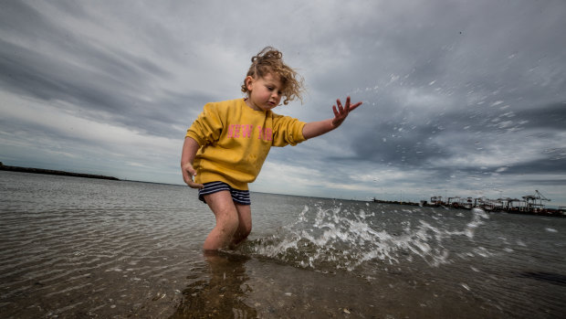 Flora Weiss, 4, enjoys the water in Port Melbourne on the last day of winter. 
