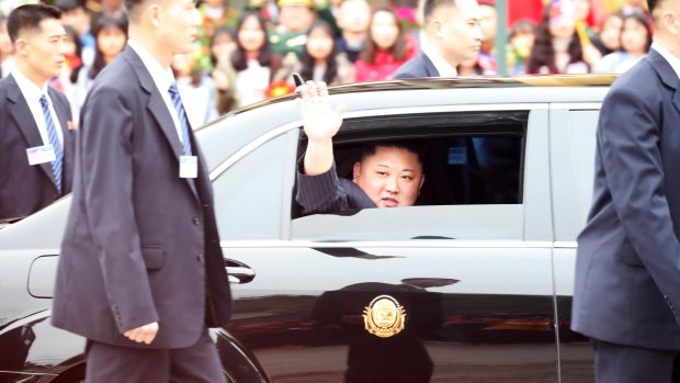 North Korean leader Kim Jong-un waves as his motorcade leaves Vietnam's Dong Dang Station bordering China for Hanoi on Tuesday.