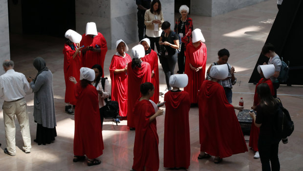 Demonstrators protesting against Supreme Court nominee Brett Kavanaugh, wear costumes from "The Handmaid's Tale". 