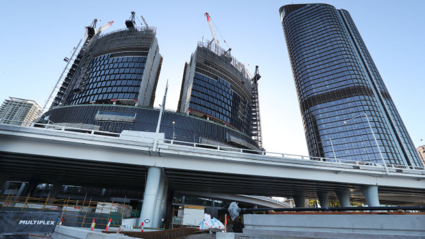 Construction of Star’s Queen’s Wharf casino in Brisbane (left) next to the state government’s “Tower of Power”.