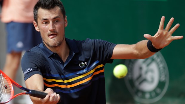 Bernard Tomic returns the ball to Argentina's Marco Trungelliti.