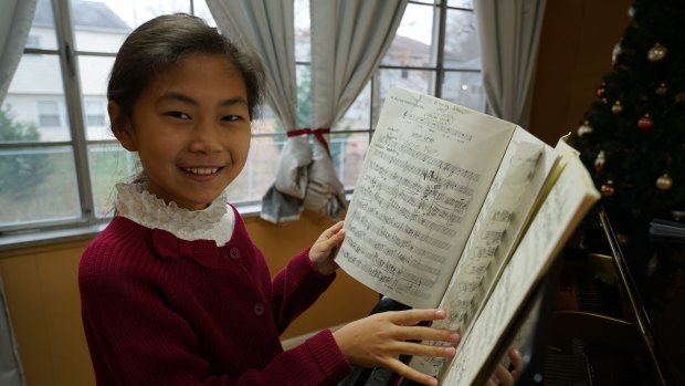 Former Perth eight-year-old pianist Anwen, who now lives in New York, practices piano three hours a day.