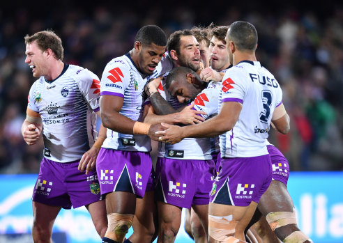 Big play: Storm captain Cameron Smith (centre) reacts with teammates after kicking the match-winning field goal.