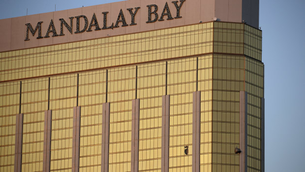 Curtains billow out of broken windows at the Mandalay Bay hotel room occupied by the shooter on the Las Vegas Strip.