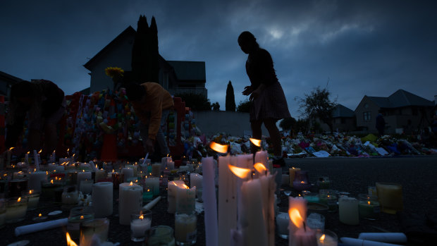 Candles are lit by school children  for the victims of Friday's attacks on Christchurch mosques.