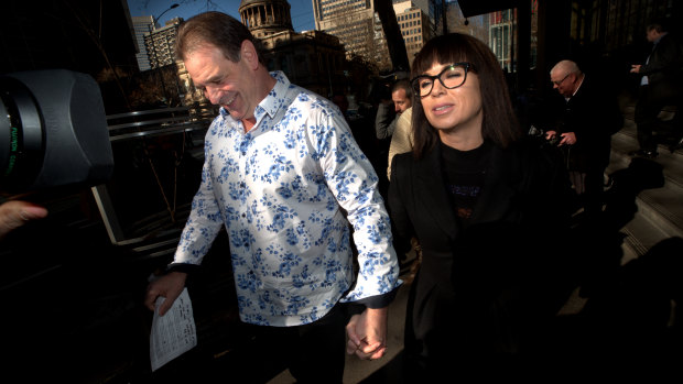 John Setka smiles as he leaves court with Emma Walters. 