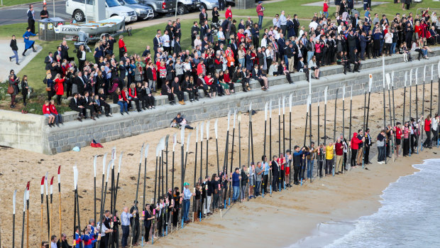 Mourners gather together at Port Campbell to honour Ross and Andrew Powell.
