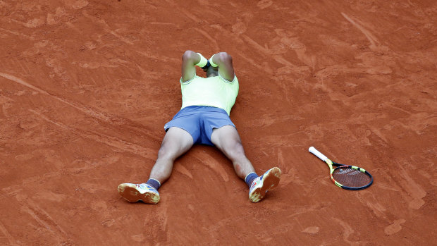 Rafael Nadal collapses onto the court after winning the French Open on Sunday.
