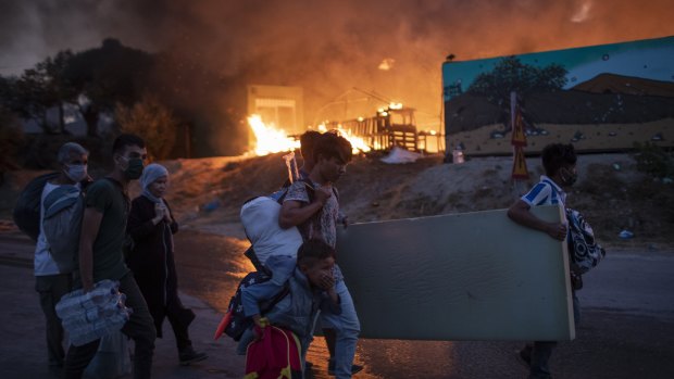 Migrants flee from the Moria refugee camp during a second fire, on the north-eastern Aegean island of Lesbos, Greece.