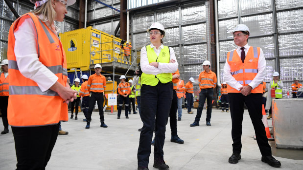 Queensland Premier Annastacia Palaszczuk (centre), Treasurer Cameron Dick (right) and Minister for State Development Kate Jones (left) at the Cross River Rail's Roma street station construction site.