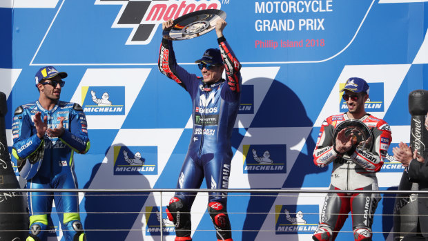 Trophy moment: Spain's Maverick Vinales (centre) celebrates after winning the Australian Motorcycle Grand Prix 2018 while (left) Italy's Andrea Iannone of Team Suzuki Ecstar in second and (right) Italy's Andrea Dovizioso of Team Ducati watch on.