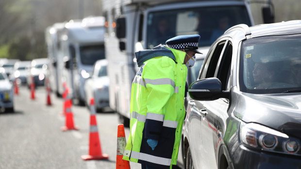 Here we go again: Queues stretch for kilometres in and out of Auckland as police stop vehicles at a checkpoint.