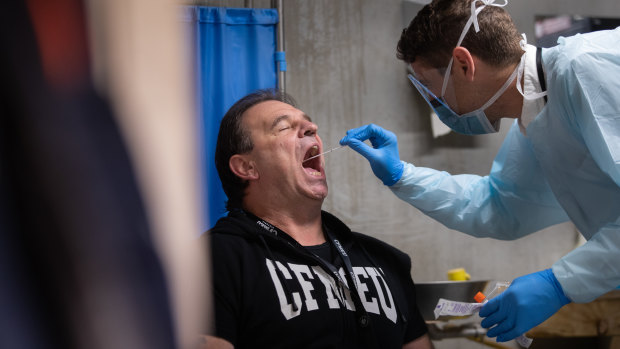 CFMEU Victorian secretary John Setka receives a coronavirus test at a mobile health bus at Multiplex Melbourne Square construction site.