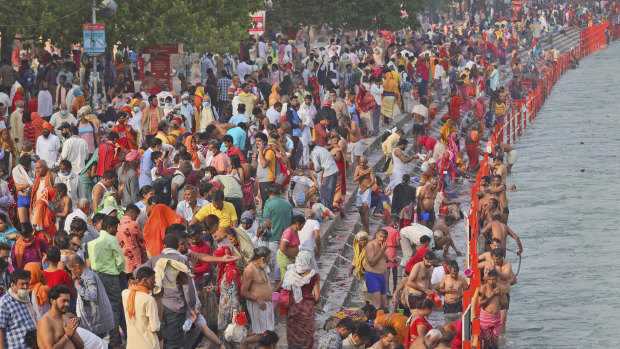 Devotees take holy dips in the river Ganges during the religious observance of Kumbh Mela, in Haridwar.