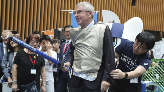 Bach performs mock fencing with a Japanese junior high school student. He appears to enjoy the reflected glory of engineering impossible scenarios.
