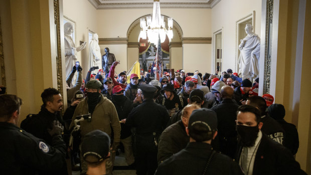 Members of the US Capitol Police trying to block demonstrators from reaching the House Floor.