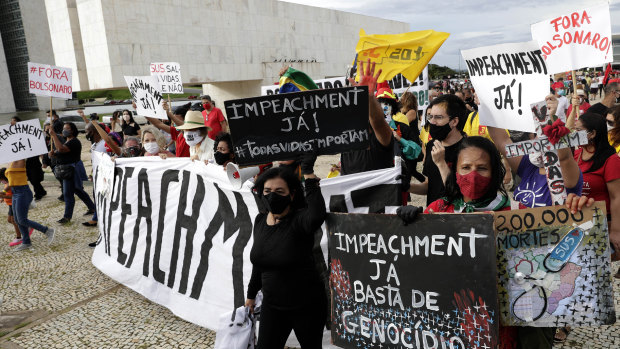 Demonstrators shout “Bolsonaro Out” and carry signs written in Portuguese calling for the impeachment of Brazilian President Jair Bolsonaro impeachment in Brasilia on Sunday.
