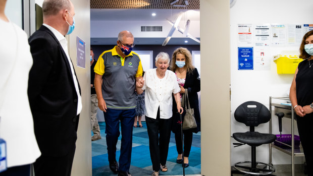 Prime Minister Scott Morrison accompanies Jane Malaysiak, the first person to get the coronavirus vaccine in Australia, to get her second dose.