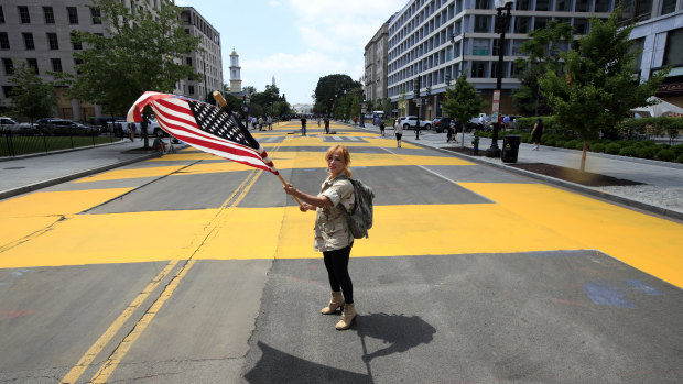 Beth Shafa waves an American flag near the White House.