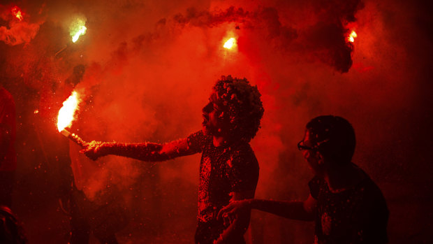 Supporters of the Muslim Brotherhood wave lit flares to protest against the Egyptian court ruling of the death sentence for ousted Islamist President Mohammed Morsi over a mass prison break during the country's 2011 uprising, while holding a rally in Cairo in  2015.